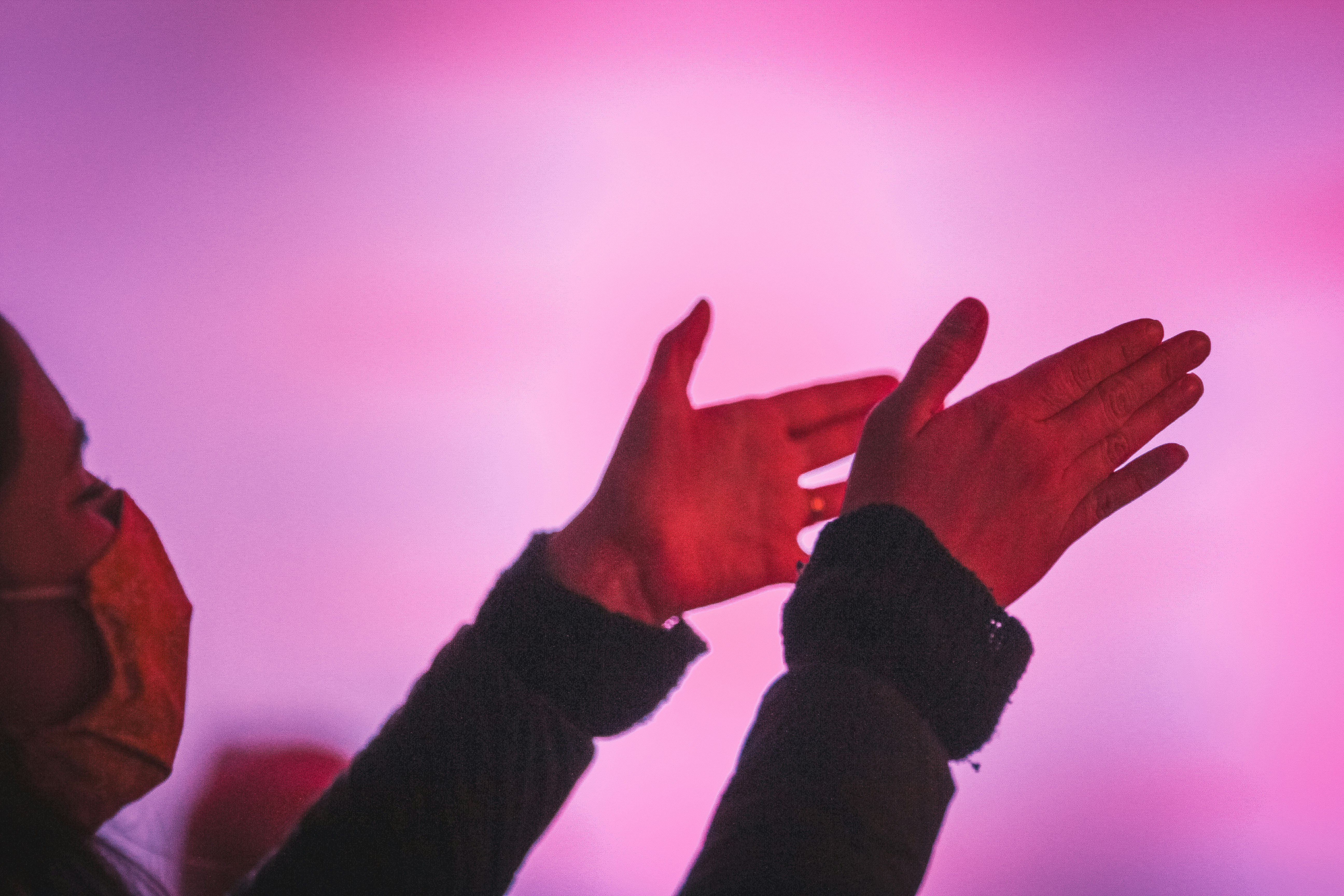 person in black long sleeve shirt showing left hand